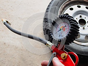 Hand holding machine Inflated pressure gauge for car tyre pressure measurement for automobile wheels. Air compressor gun with