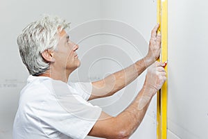 Checking wall with spirit level