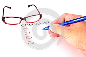Checklist with pen, glasses and checked