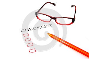 Checklist with pen, glasses and checked