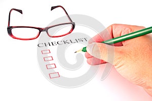 Checklist with pencil, glasses and checked