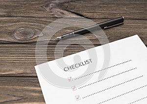 A checklist on a sheet of paper, a pen