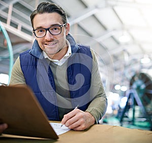 Checklist, smile and portrait of businessman for inventory management, logistics or stock inspection in warehouse