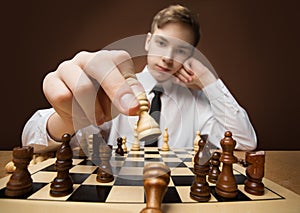 Checkmate. Chess Player Victory holding Chess Piece and throw off opposite King. Teenager Boy Leader win in Strategy Game. Studio