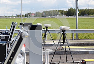 Checkpoint police on the road. cameras on tripods and equipment in cases for inspection of entering cars on the road