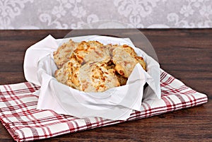 Cheddar, garlic biscuits in a napkin lined basket. Selective foc