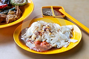 Chee Cheong Fun or Rice noodle roll served with sauces, and a sprinkle of sesame and shallot is popular Chinese food in