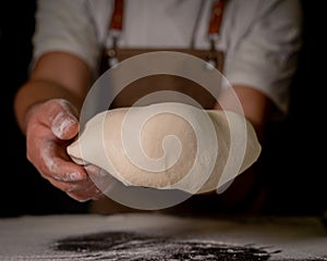 Cheef showing the dough to prepare his handmade pizza