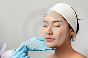 Cheek filler injection treatment injection. Woman face plastic surgery. Beauty and cosmetic concept. Skincare and anti aging theme