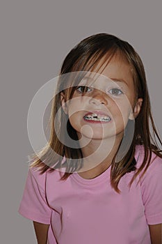 Cheekily schoolgirl with long hair and freckles