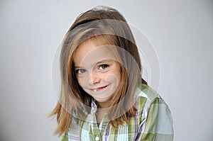 Cheekily schoolgirl with long hair and freckles photo