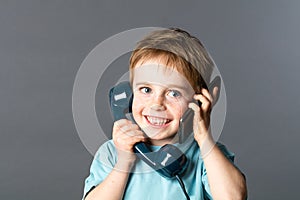 Cheeky boy talking on both ears for two voices communication