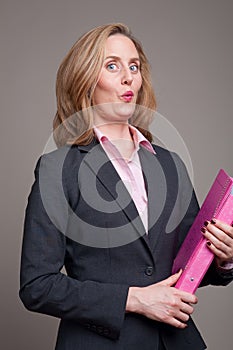 Cheeky businesswoman with pink folder