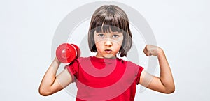Cheeky child pouting, raising hands with dumbbell and strong fist