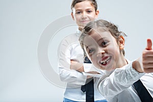 Cheeky enthusiastic little girl giving a thumbs up