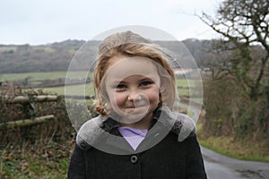 Cheeky looking girl on country walk photo