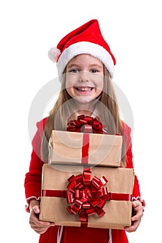 Cheered and happy christmas girl holding two gift boxes in the hands, wearing a santa hat isolated over a white