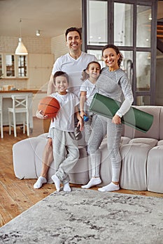 Cheerful active family doing sport at home