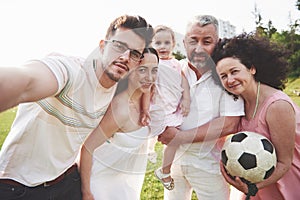 Cheerful active family having fun at countryside in summer day.