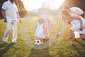 Cheerful active family having fun at countryside in summer day.