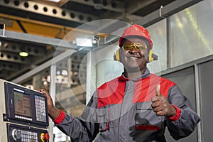 Cheerful African American CNC Machine Operator Standing Next To CNC Controller Console And Giving Thumb Up