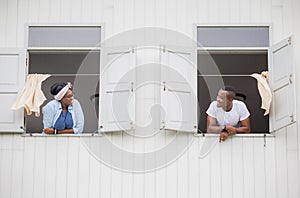 Cheerful african american couple at window, happiness family concepts
