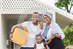 Cheerful african american family with luggage and carrying boxes into new home, Happiness family on moving day concepts