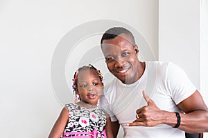 Cheerful african american father and daughter playing in living room, Happiness family concepts