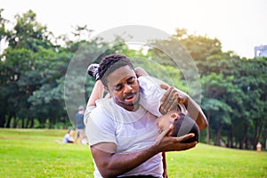 Cheerful african american father and son playing in park, Happiness family concepts, parent and child play in park