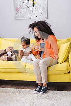 cheerful african american mother holding baby