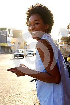 Cheerful african american woman with cell phone outdoors