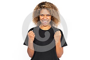 Cheerful African American woman with clenched fists