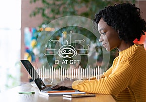 Cheerful african american woman using chat gpt on laptop