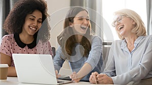 Cheerful african and caucasian businesswomen laughing having fun at workplace