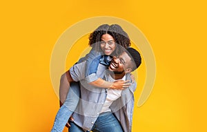Cheerful African Couple Having Fun Together, Guy Piggybacking His Girlfriend