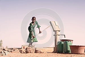 Cheerful African ethnicity Offspring with healthful Water in a village photo