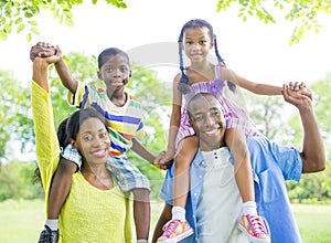 Cheerful African Family Bonding Outdoors