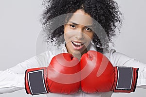 Cheerful African girl wearing red boxing gloves