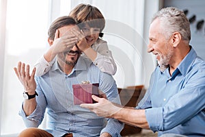 Cheerful aged man presenting a gift