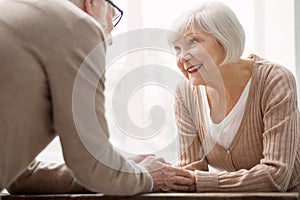 Cheerful aged woman being with her husband