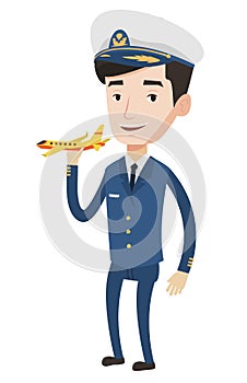 Cheerful airline pilot with model airplane.