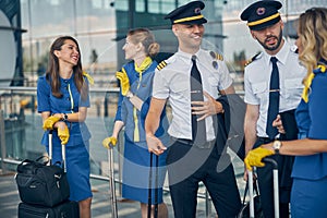 Cheerful airline workers chatting on the street