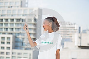 Cheerful altruist woman looking at her mobile phone