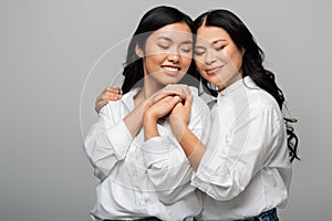 cheerful asian mother and young adult