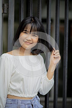 Cheerful asian teenager happines smiling face standing outdoor
