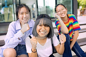 Cheerful asian teenager at school bulding photo
