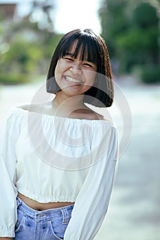 Cheerful asian teenager toothy smiling face with happiness moment