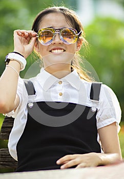 Cheerful asian teenager wearing two of eyes glasses