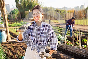 Cheerful asian woman ready to work in her home garden