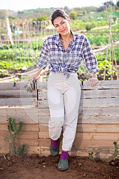 Cheerful asian woman ready to work in her home garden